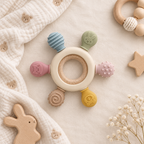 Wooden ring silicone teether toy styled with a soft neutral baby blanket and small toys