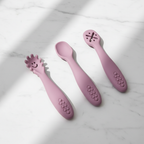Set of 3 silicone baby spoons in powder rose lifestyle shot