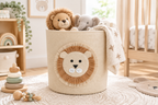 Beige felt lion storage basket in a bright nursery filled with soft toys and a folded blanket