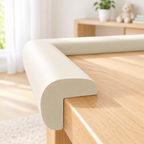 Soft foam edge bumper strip installed on a wooden table corner