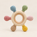 Wooden ring silicone teether toy with pastel animal shapes on a neutral background