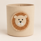Beige felt storage basket with a lion face applique on a neutral background