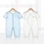 Sky blue and white baby rompers hanging on wooden hangers